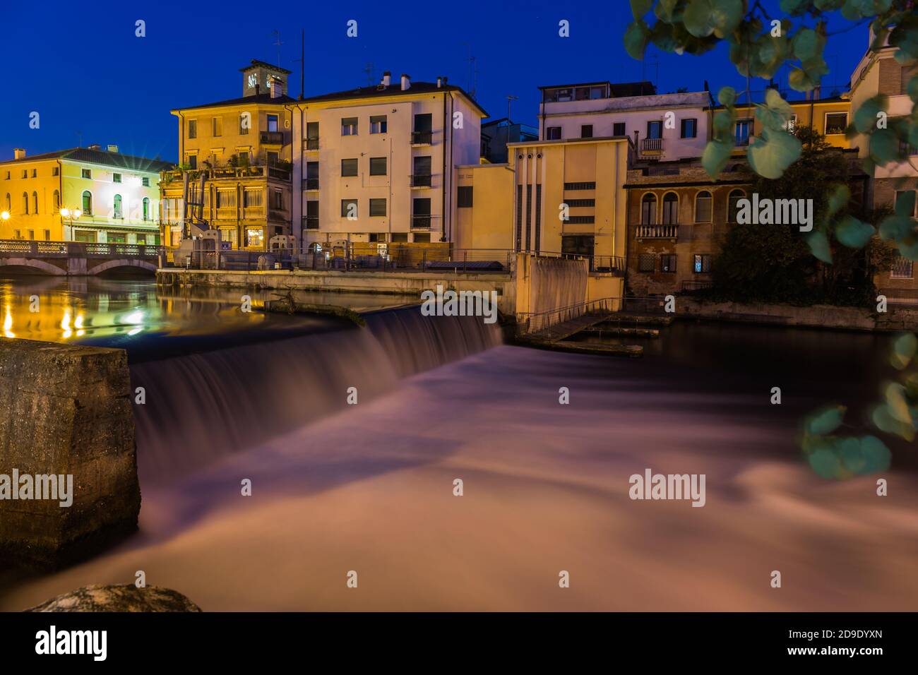 View on waterfall and a dam on Sile river with beautiful blue sky at night Treviso Italy Stock Photo