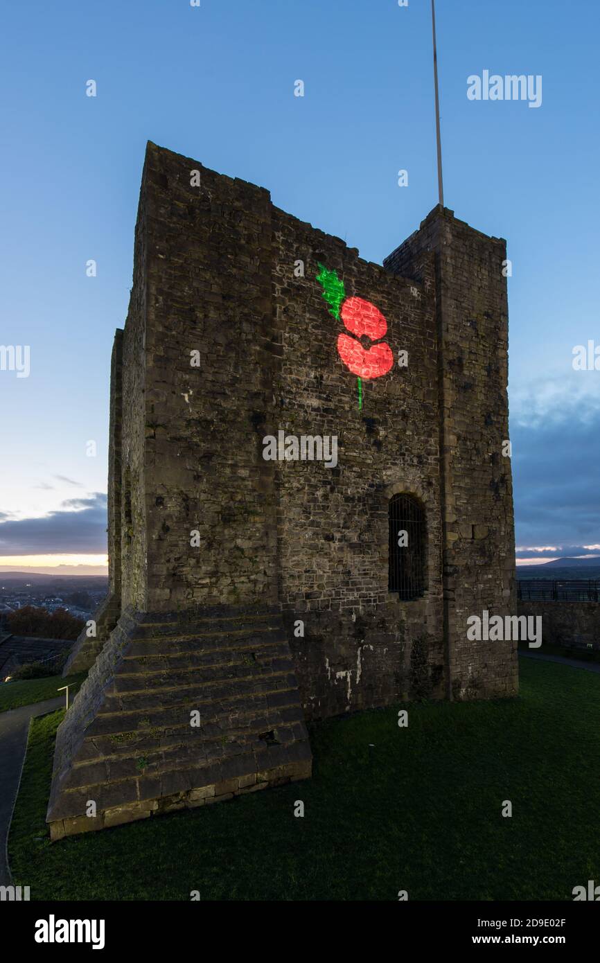 Large red poppy projected onto the wall of Clitheroe castle for remembrance day. Ribble valley, Lancashire Stock Photo