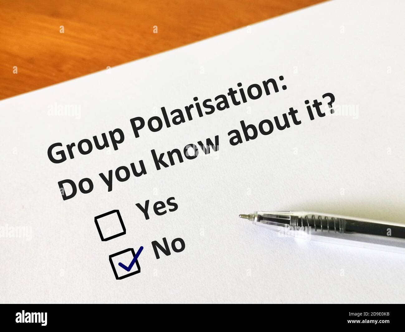 One person is answering question about group polarisation.  The person is thinking if he knows about it. Stock Photo