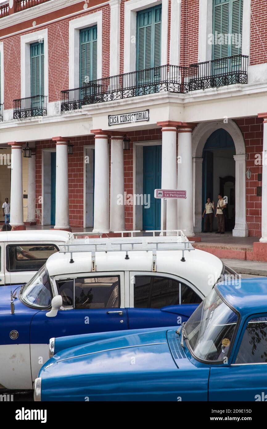 Cuba, Holguin, Classic vintage cars parked infront of Casa Consistorial
