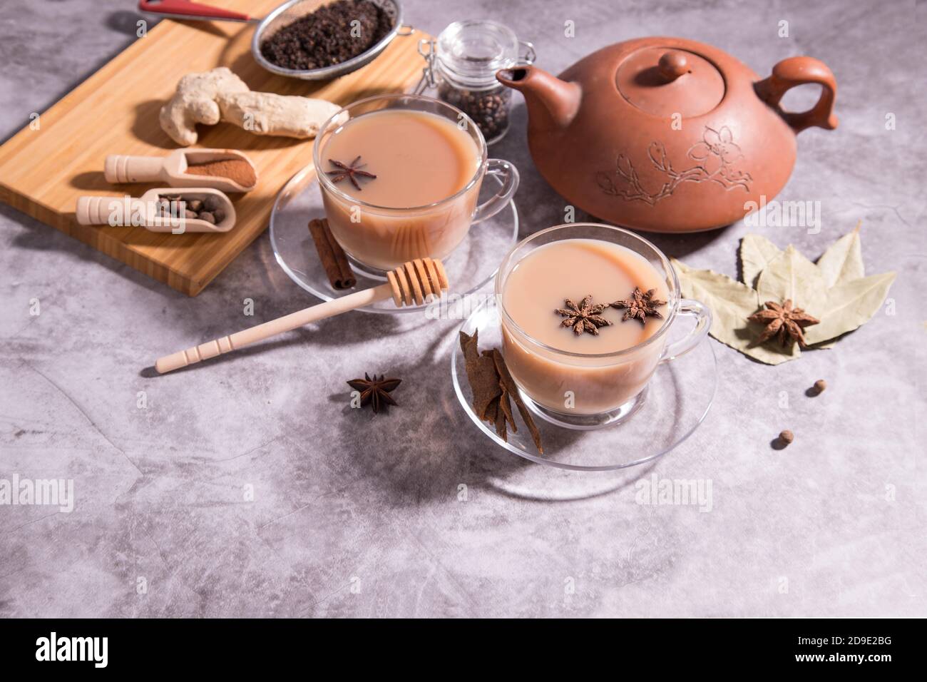 Indian tea masala tea. Tea with milk and spices in wooden spoons. Horizontal orientation Stock Photo