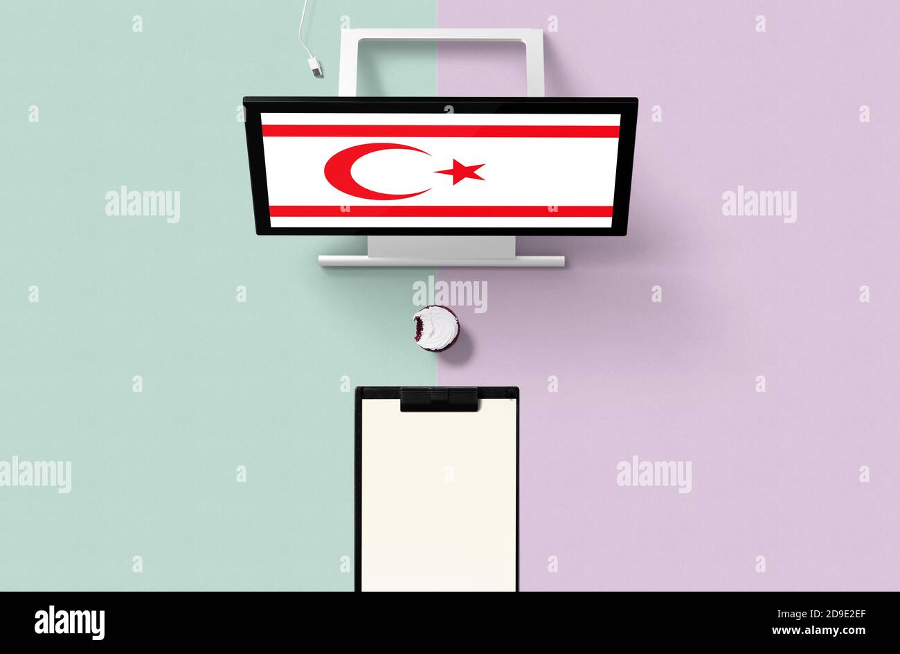 Northern Cyprus national flag on computer screen top view, cupcake and empty note paper for planning. Minimal concept with turquoise and purple backgr Stock Photo