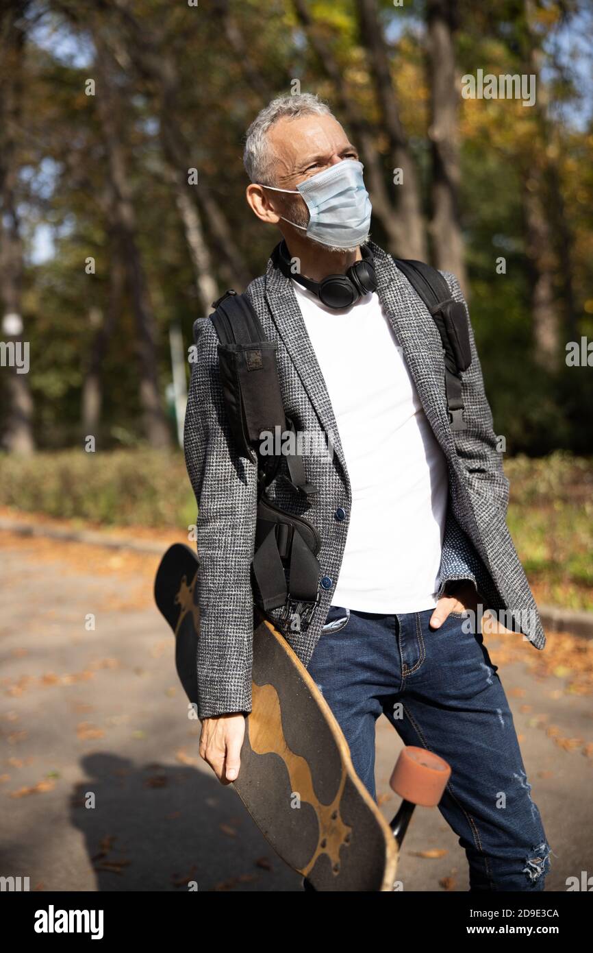 Mature handsome man in mask spending day outdoors Stock Photo