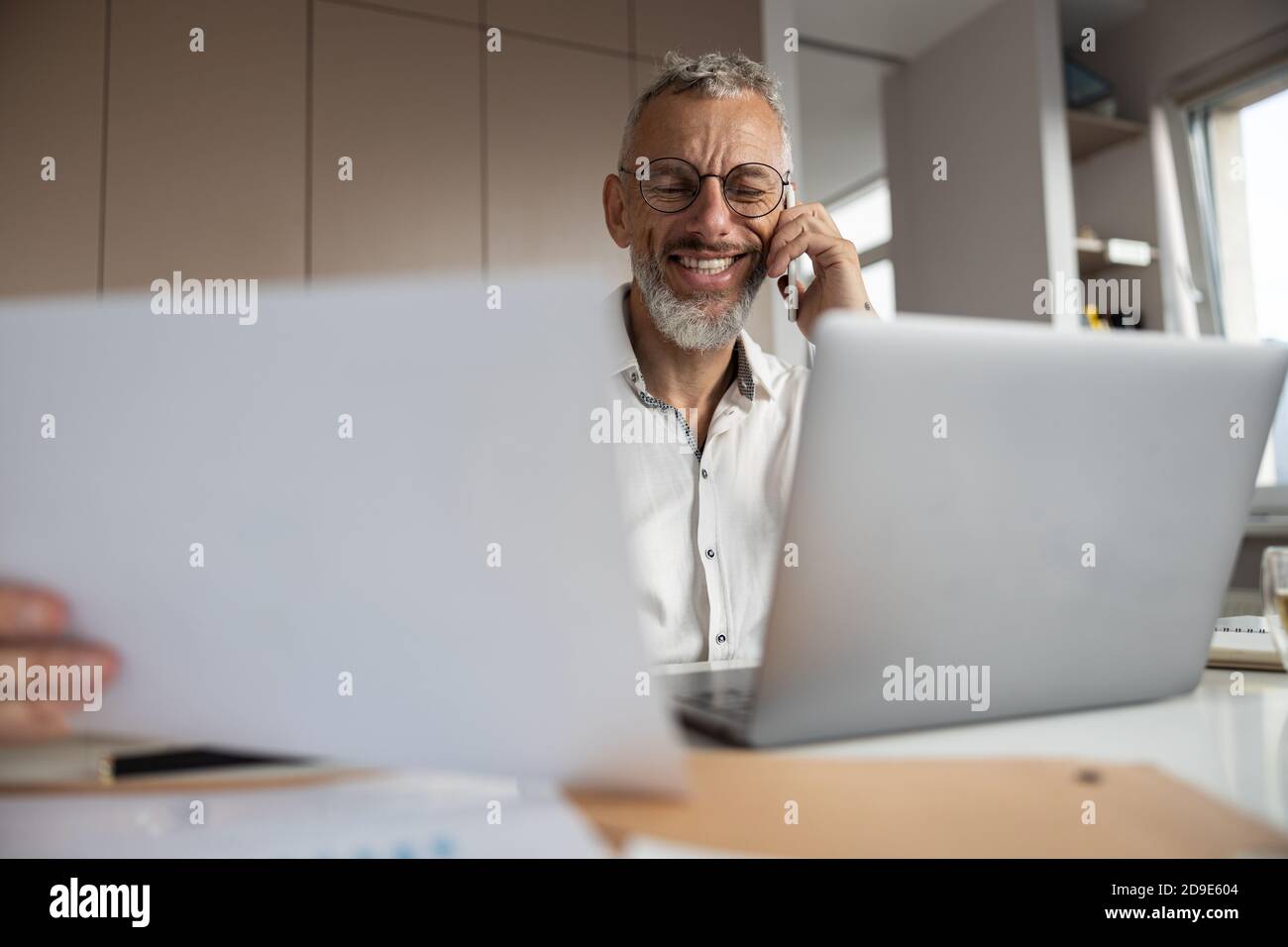 White-collar worker is discussing documents by phone Stock Photo