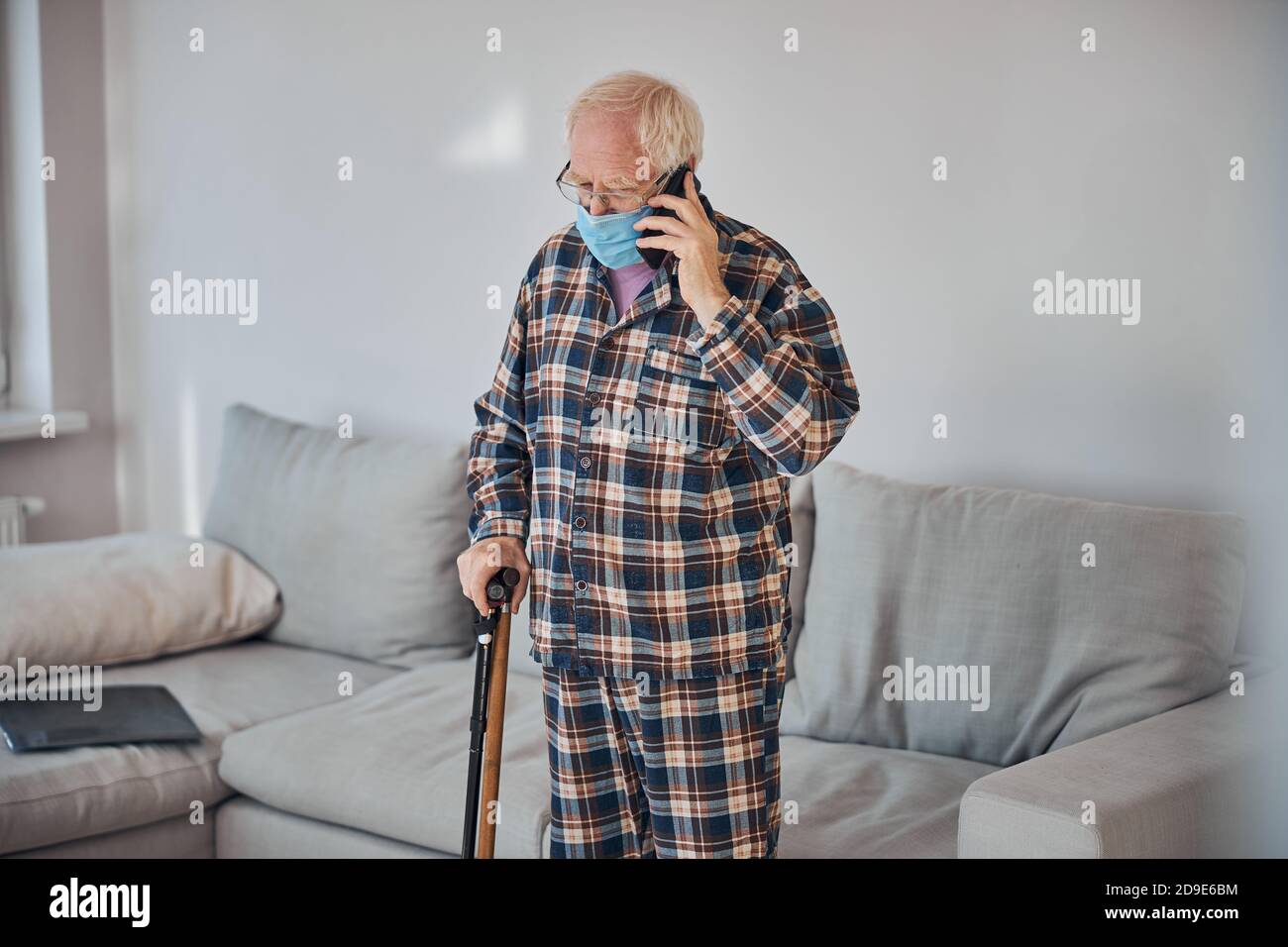 Caucasian male pensioner talking on the smartphone Stock Photo