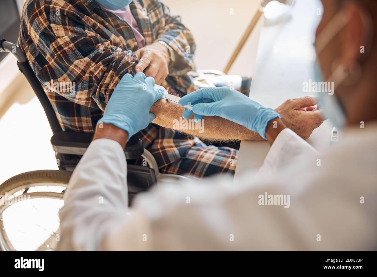 Doctor injecting insulin to a senior man Stock Photo