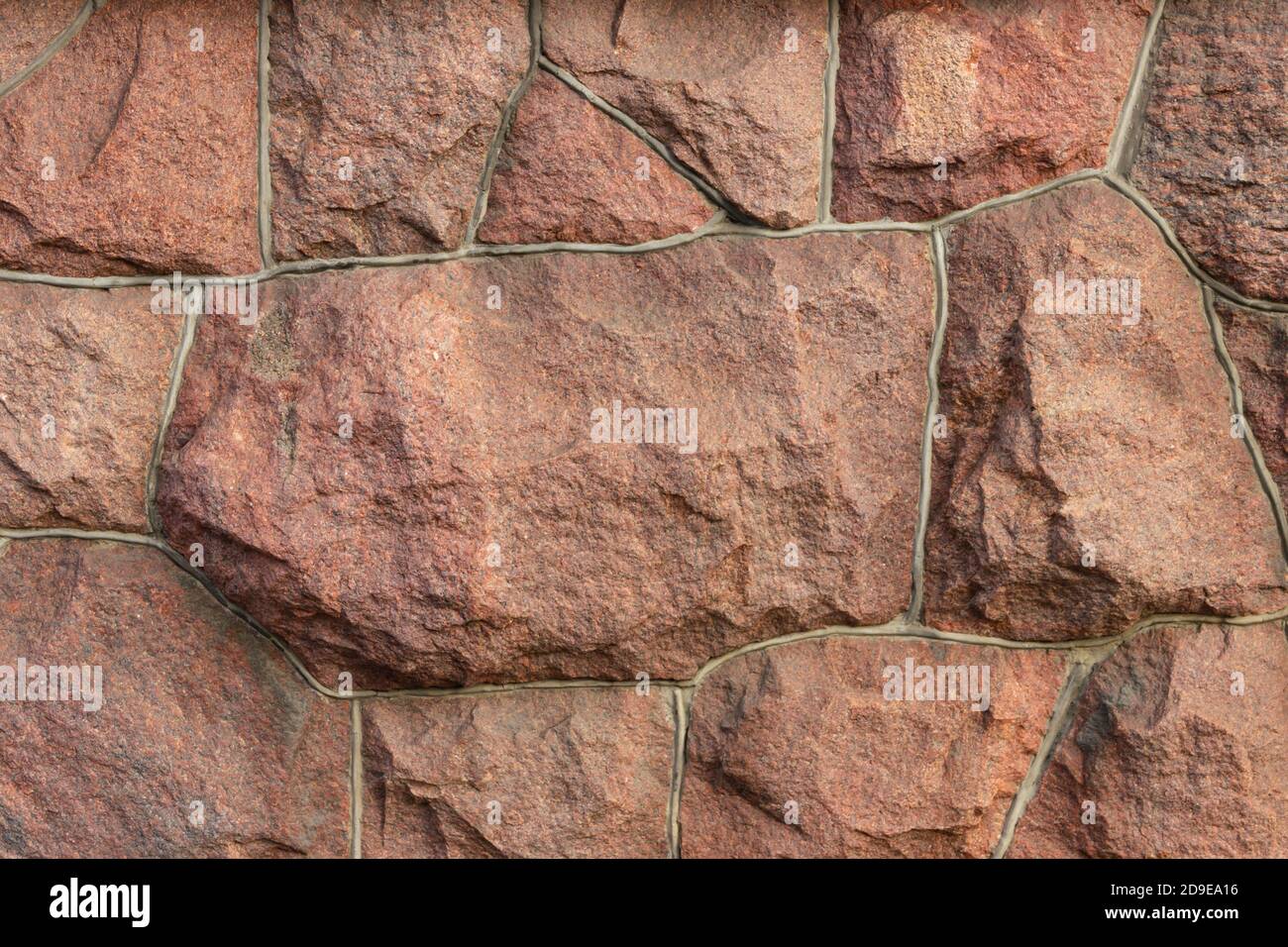 The surface of the masonry is made of roughly hewn large red stones