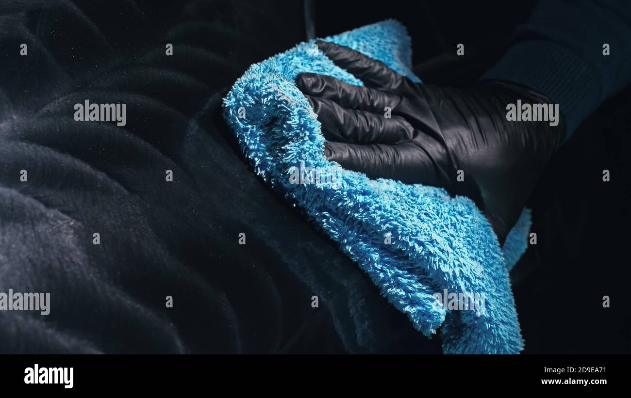 Using rag in palm of your hand, finish liquid car polish are removed