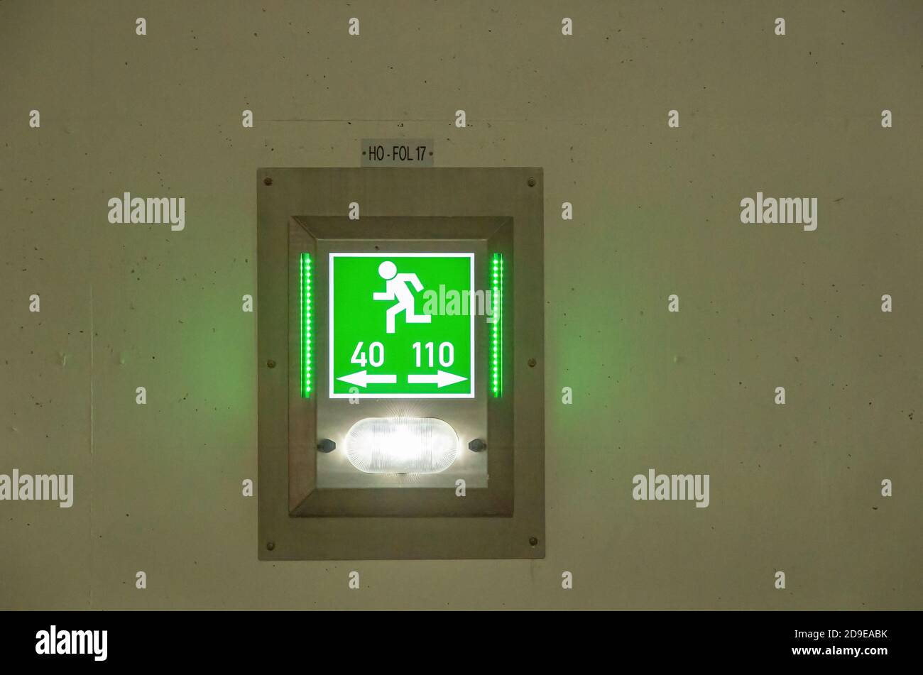 Green sign emergency exit 40 110 in a tunnel. Stock Photo