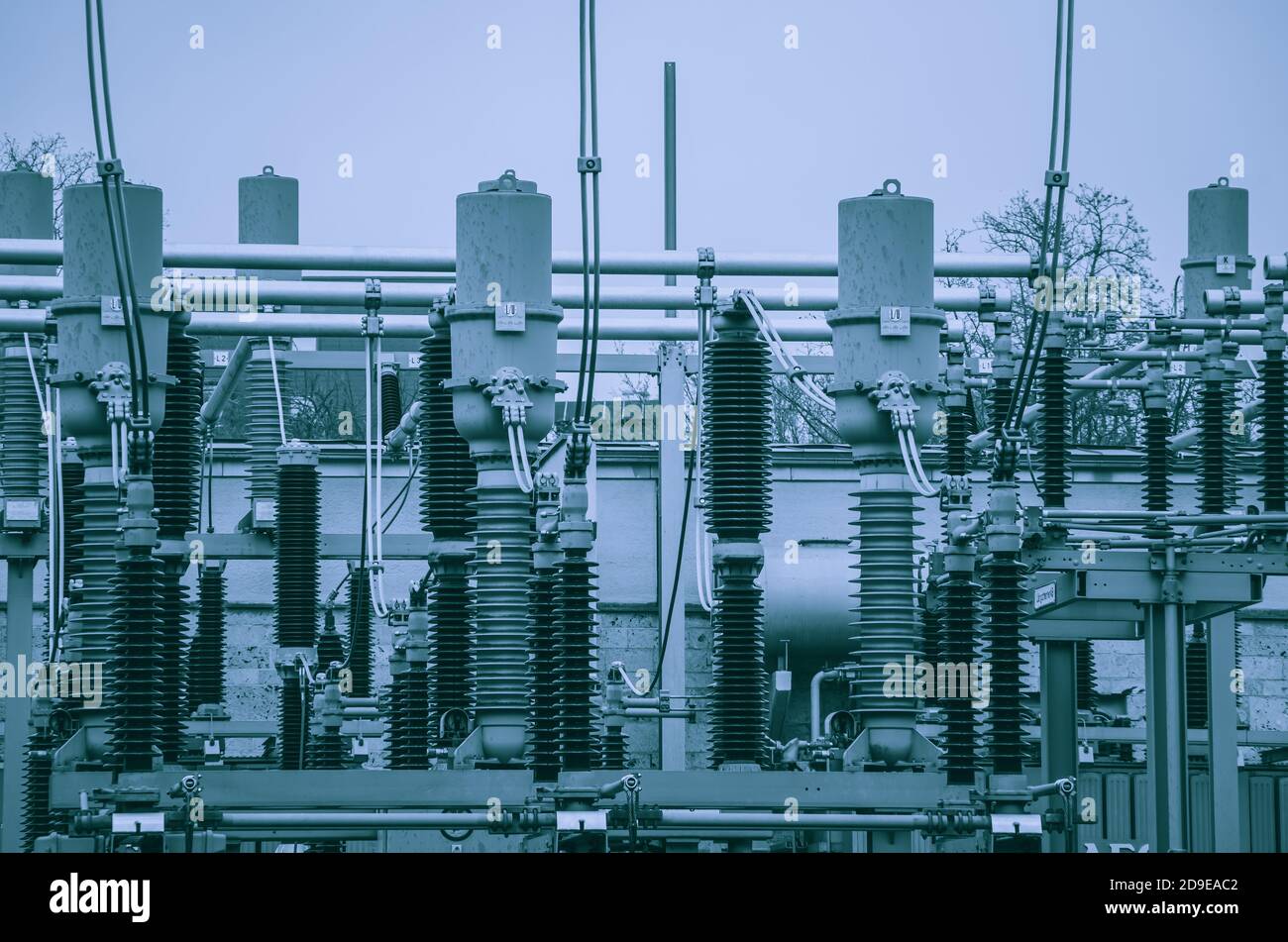 Concept of electricity and power generation using the example of insulators and devices in a transformer station. Stock Photo