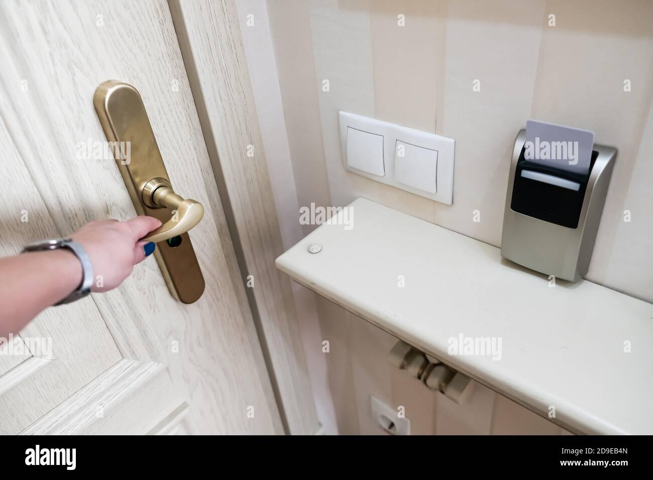 Female hand opening secure hotel door from inside. Closeup view of a