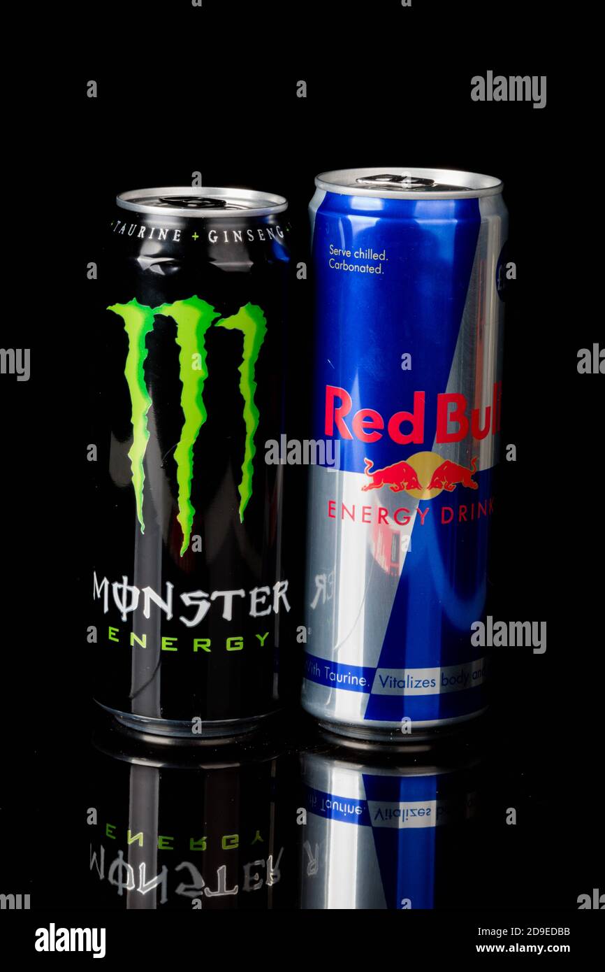 London, United Kingdom, 14th October 2020:- Cans of Monster and Redbull  Energy Drinks Isolated on a black background Stock Photo - Alamy