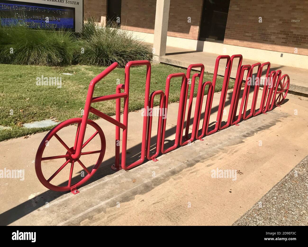 Red bike rack in shape of a bicycle in front of Garland Nicholson Librarypa Stock Photo