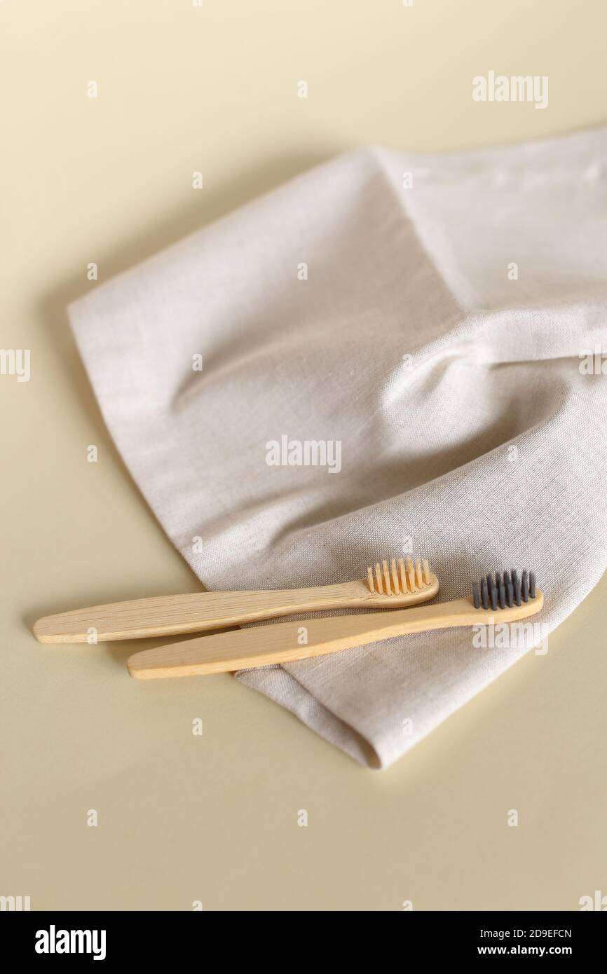 Two ecological wooden toothbrushes lying on white towel. Stock Photo