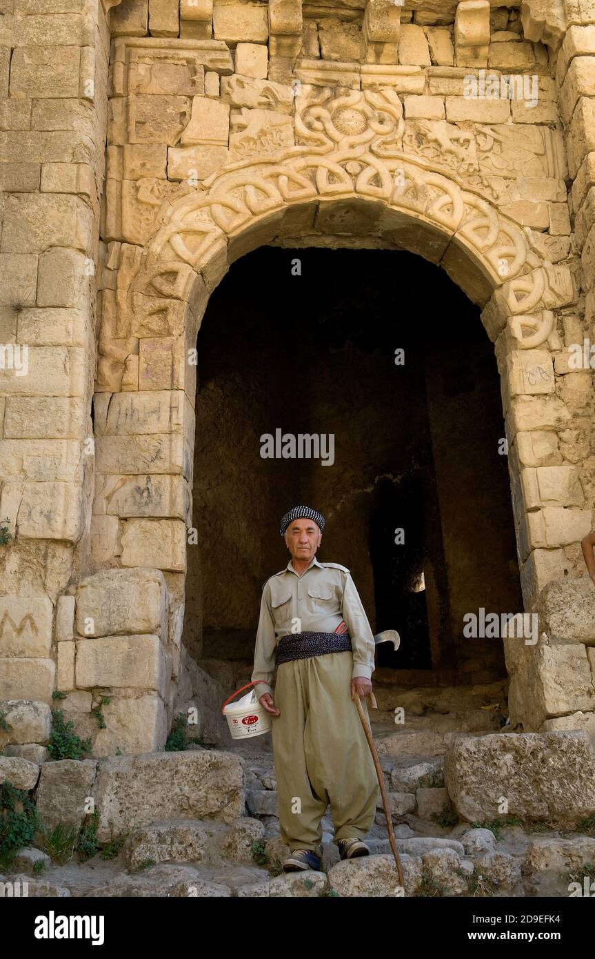 Amadiya, Iraq. October 3rd 2009  An old Kurdish man wearing traditional clothes in front of the arched Bahdinan Gate in Amadiya village in the Kurdish Stock Photo