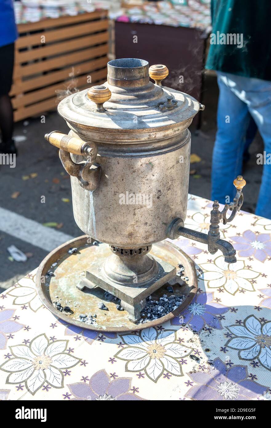 Old Russian traditional samovar for tea ceremony. Retro soot grunge tea samovar was used for a long time. Burned with firewood Stock Photo
