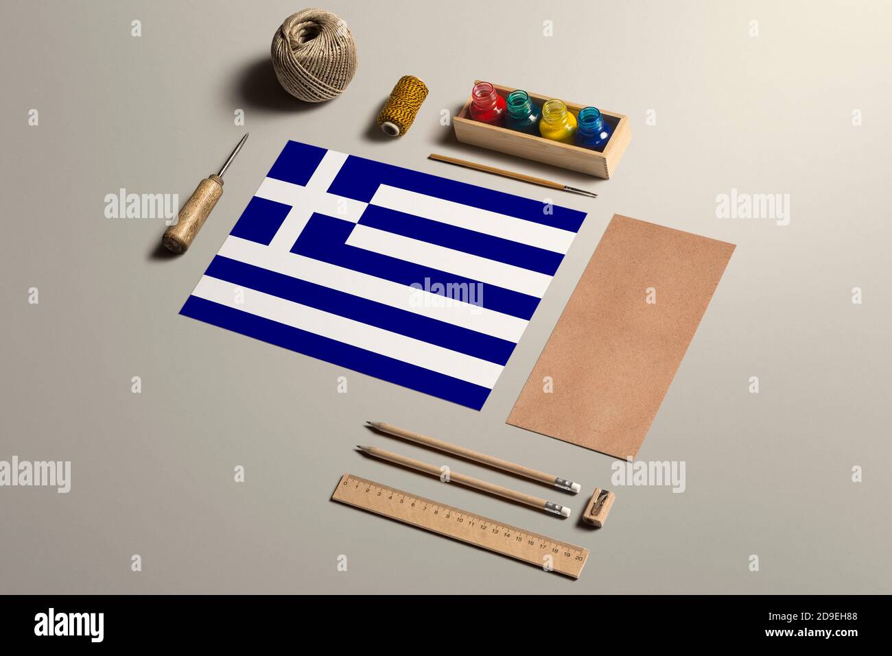 Greece calligraphy concept, accessories and tools for beautiful handwriting, pencils, pens, ink, brush, craft paper and cardboard crafting on wooden t Stock Photo