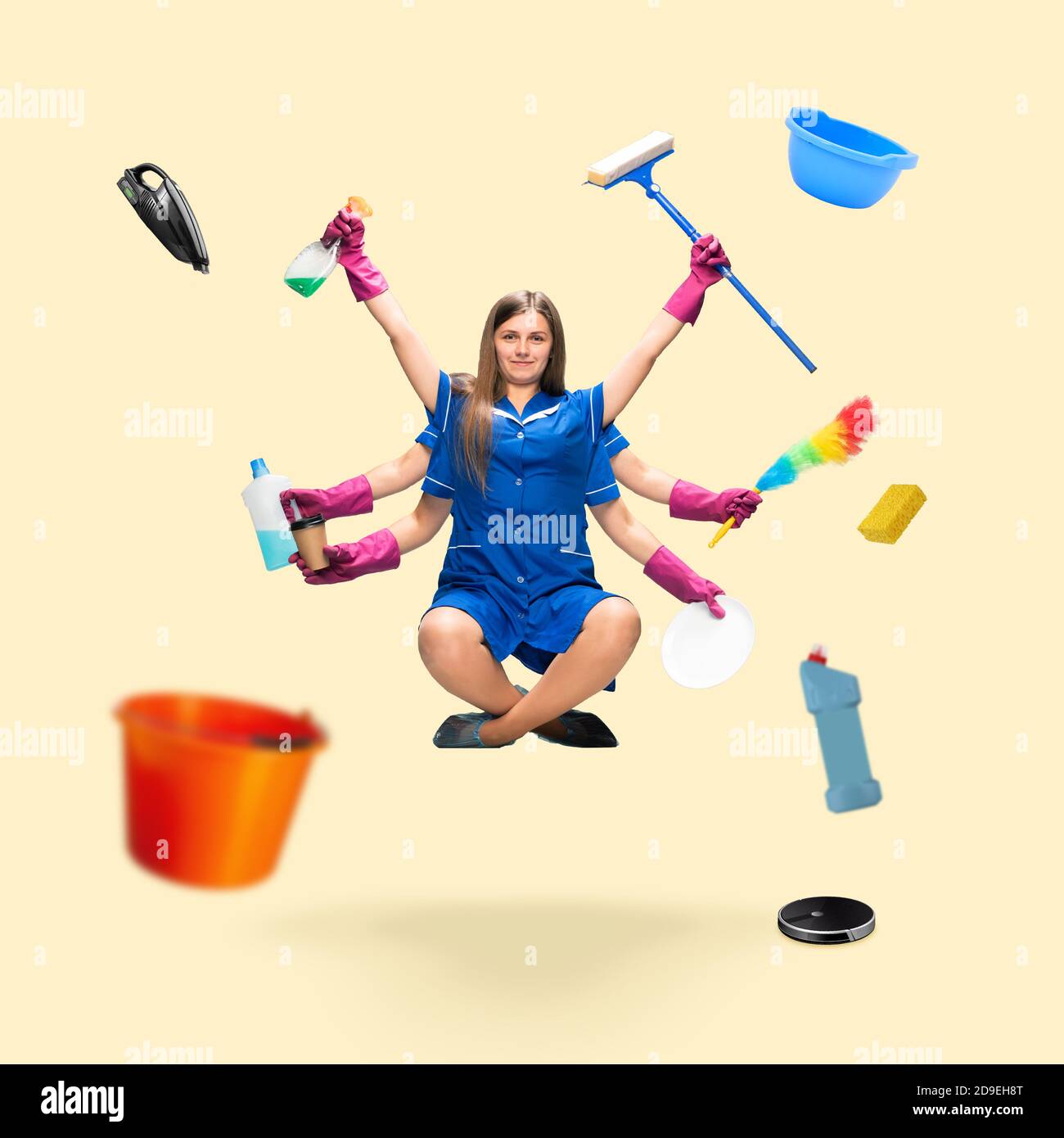 Handsome maid, multi-armed housemaid levitating isolated on yellow studio background with equipment. Concept of professional occupation, work, job, housekeeping, time management. Multi-task like Shiva. Stock Photo
