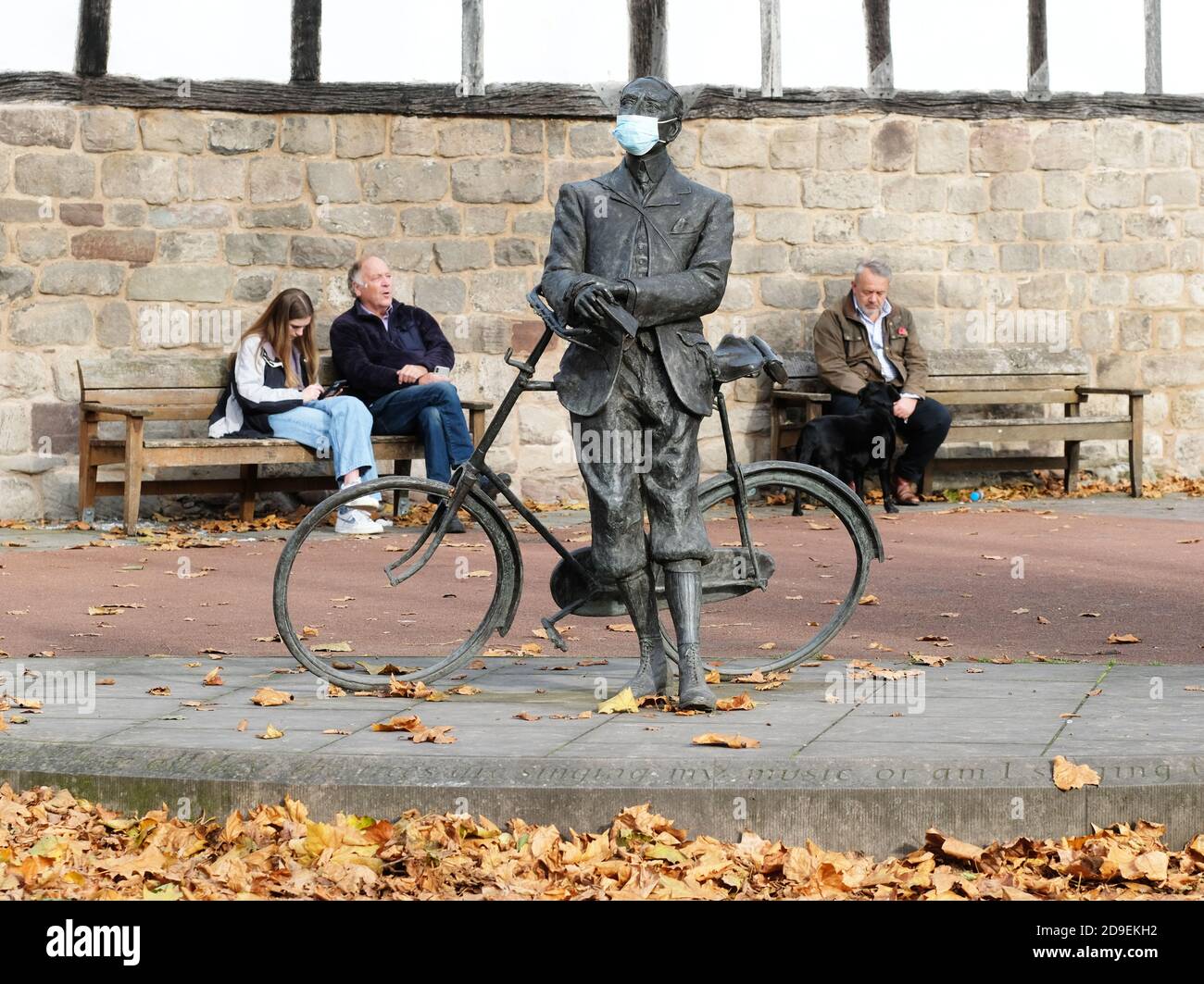 Hereford, Herefordshire, UK - Thursday 5th November 2020 - As England enters into its second Covid lockdown a protective faskmask has been added to the statue of composer Sir Edward Elgar on the Cathedral Green. Elgar lived in Herefordshire for many years. Photo Steven May / Alamy Live News Stock Photo