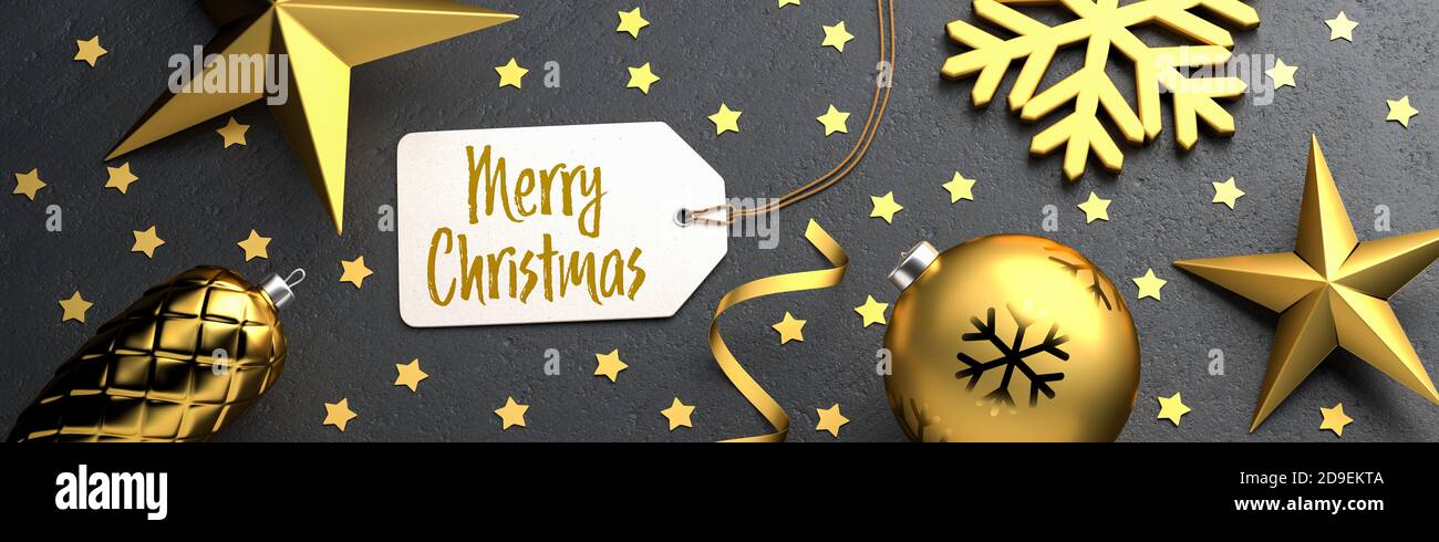 Christmas - Gift Tag with the message 'Merry Christmas' on a black stone background with gold colored christmas ornaments around. Banner size. Stock Photo
