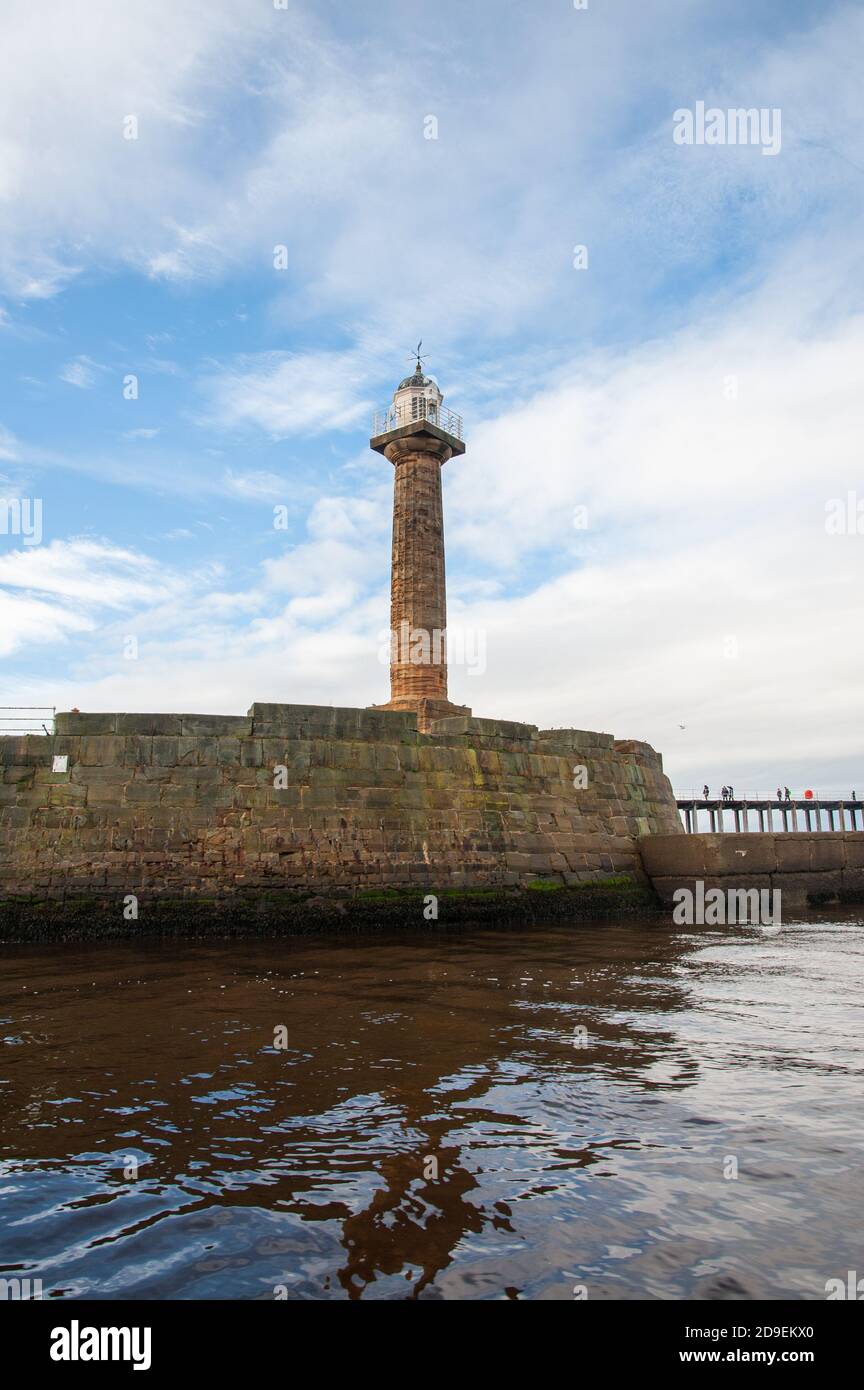 The west pier and lighthouse. Whitby Harbour, Whitby, Yorkshire, England. Stock Photo