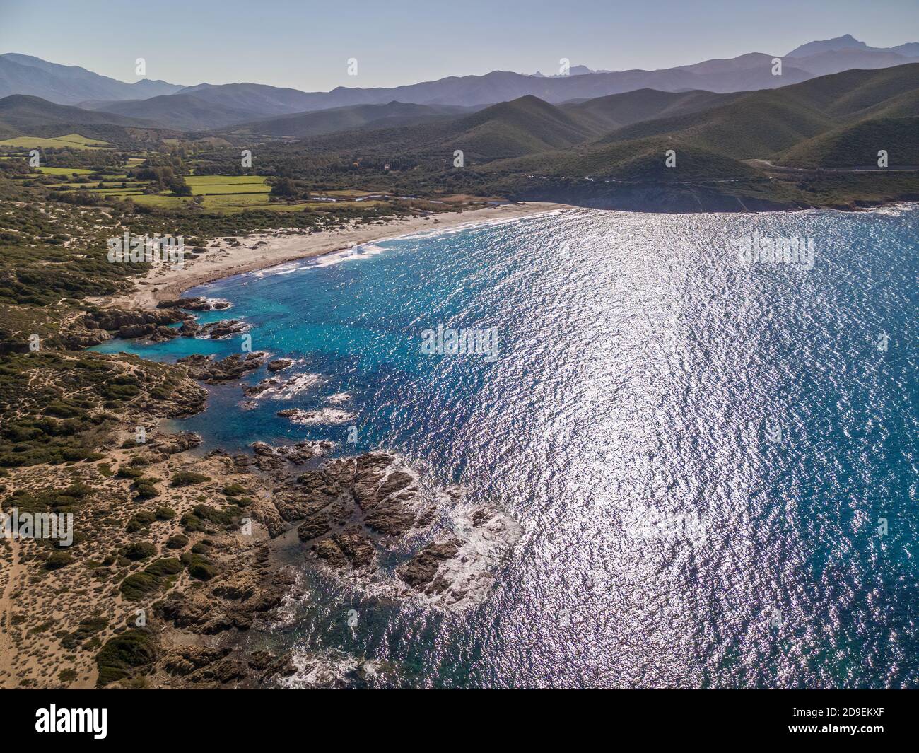 Aerial view of the turquoise mediterranean sea washing onto the white sandy beach of Ostriconi in the Balagne region of Corsica Stock Photo