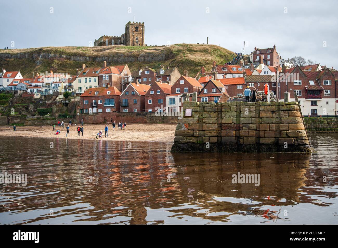 A view of the stone jetty with the abbey in the background. Whitby Harbour, Whitby, Yorkshire, England. Stock Photo