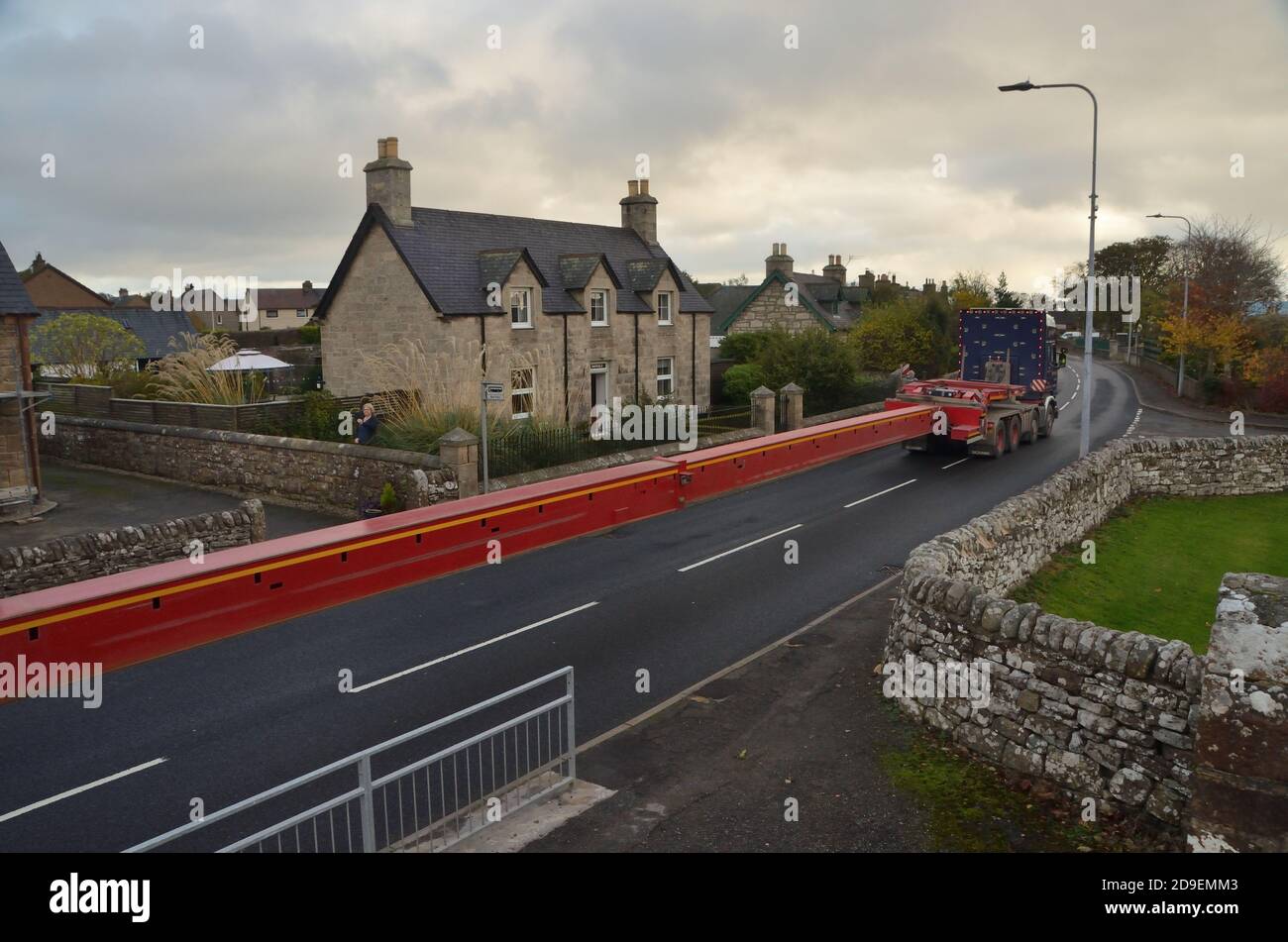 An extra long vehicle on the A9 trunk road at Golspie village, Scottish Highlands, undertaking a trial run for planned delivery of wind turbine parts. Stock Photo