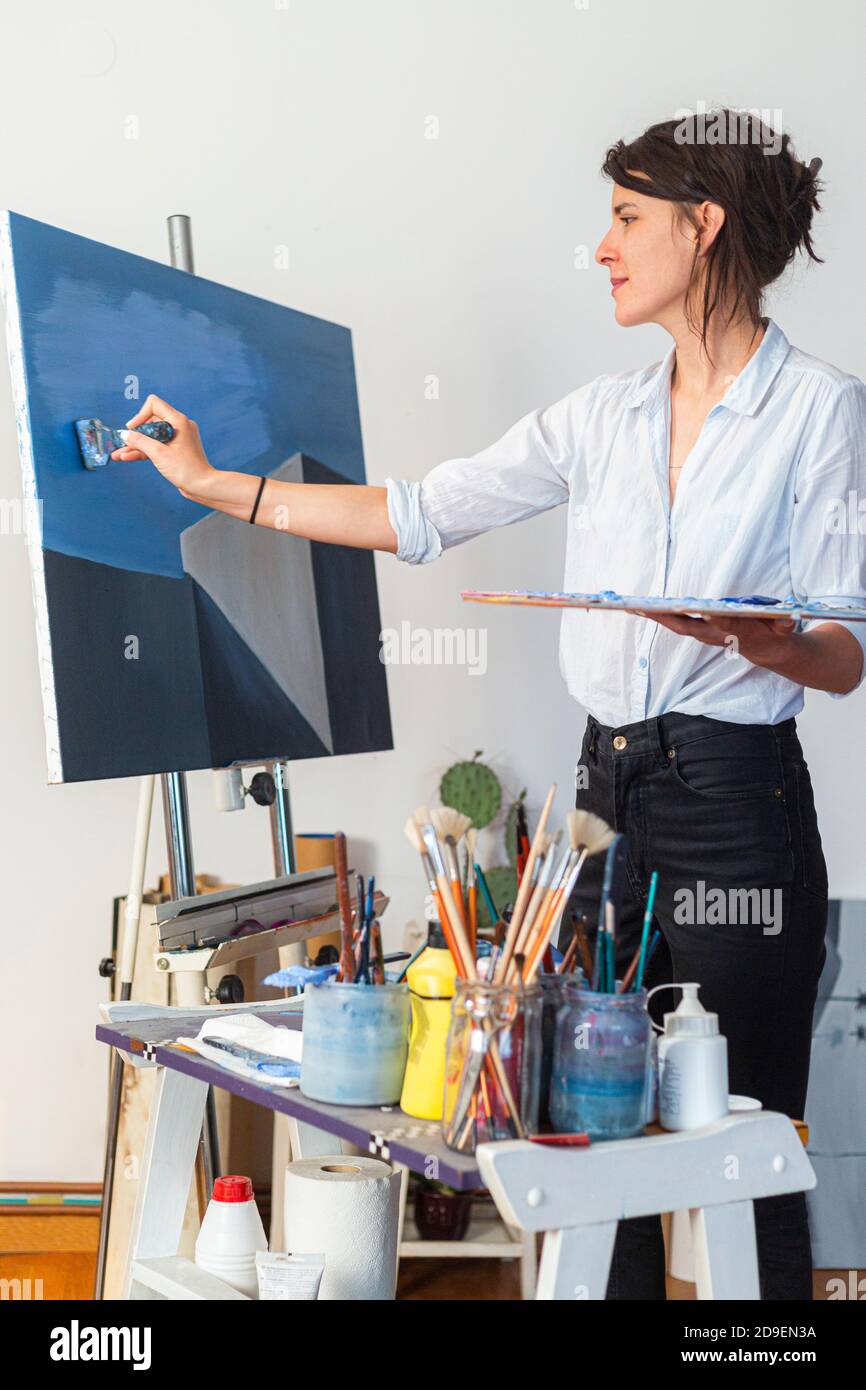 Female hand applies blue paint hi-res stock photography and images - Alamy