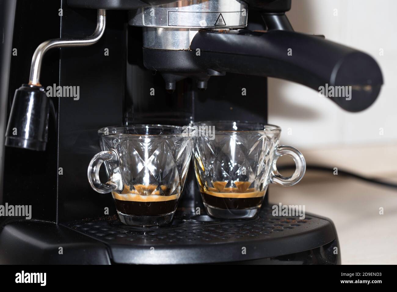 Process of making two espresso shots using espresso machine. Italian coffee. Stock Photo