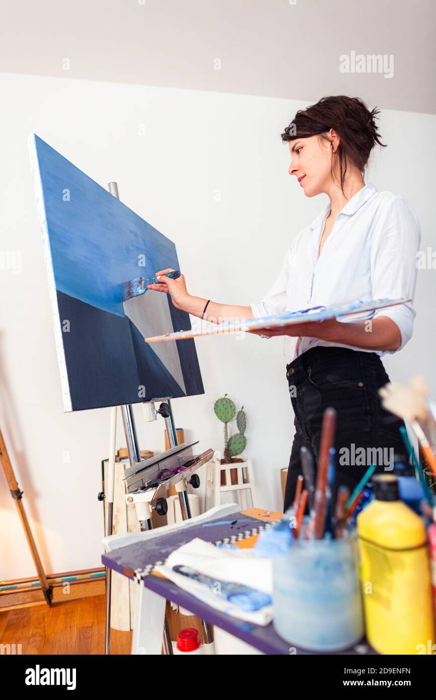 Female hand applies blue paint hi-res stock photography and images - Alamy