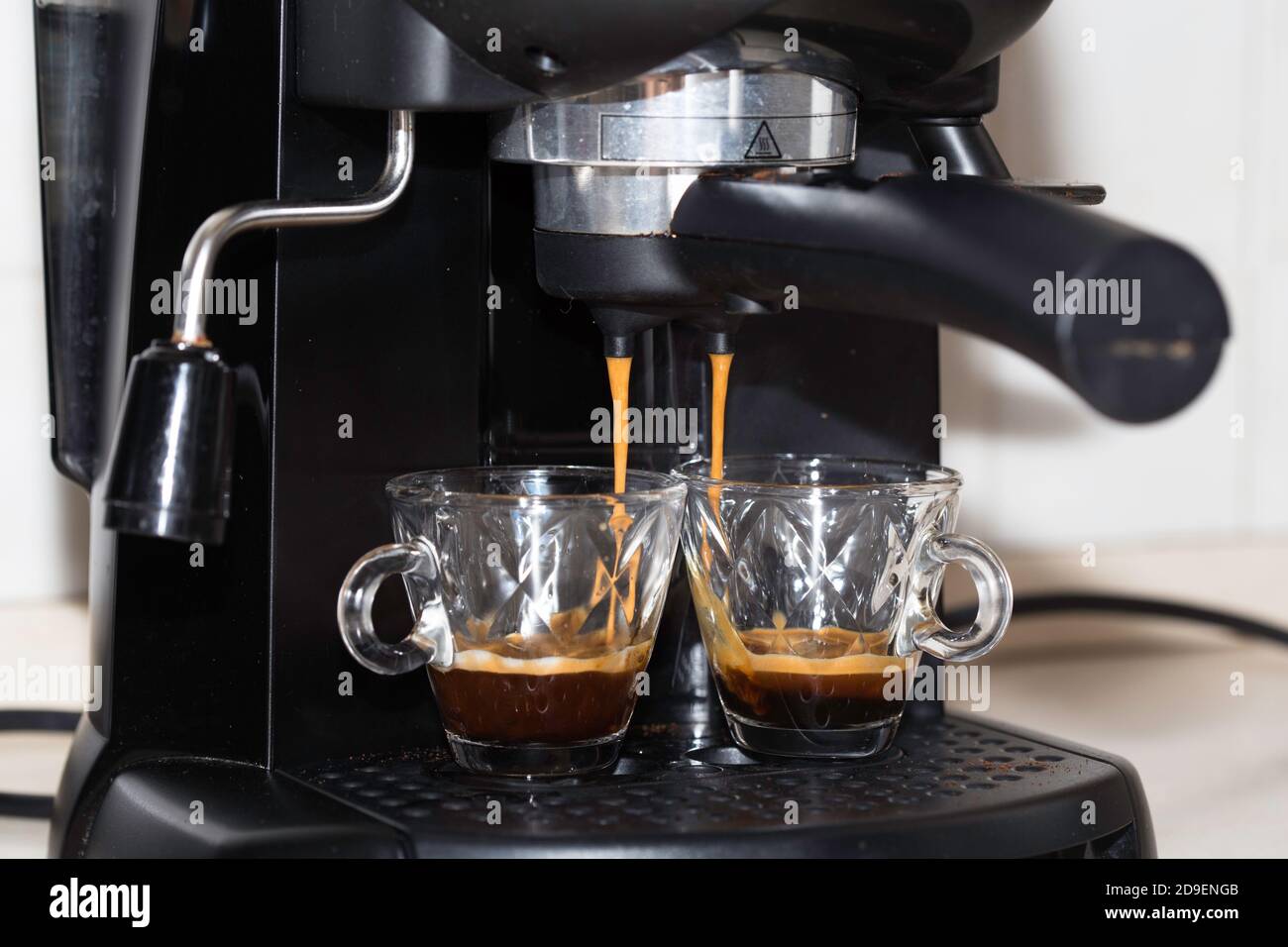 Process of making two espresso shots using espresso machine. Italian