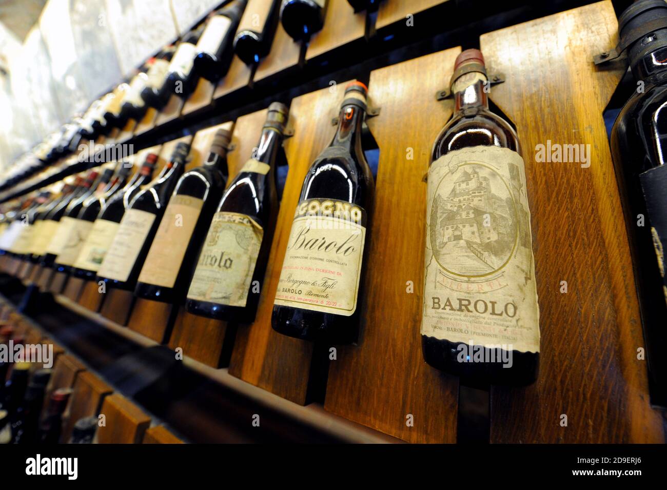 Vintage red wine bottles displayed at the Barolo wine museum, in Barolo, Piemonte, Italy. Stock Photo