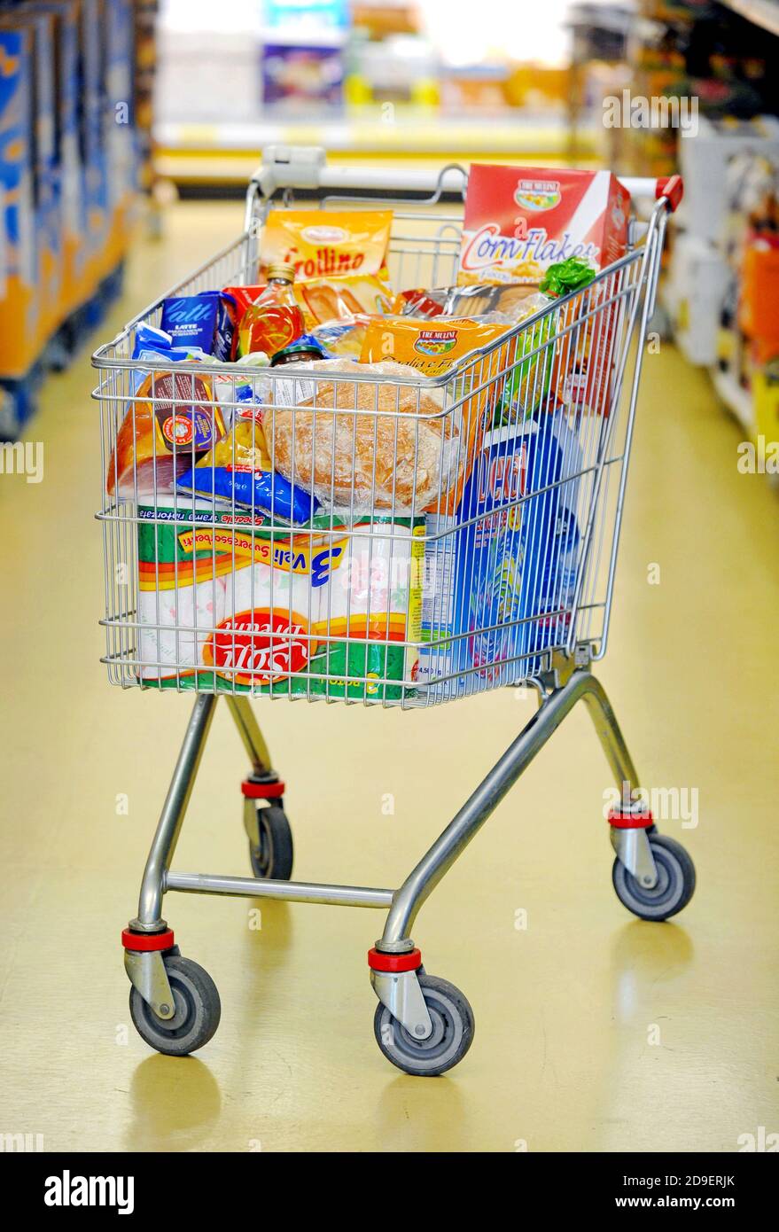 Shopping cart full in a supermarket. Stock Photo