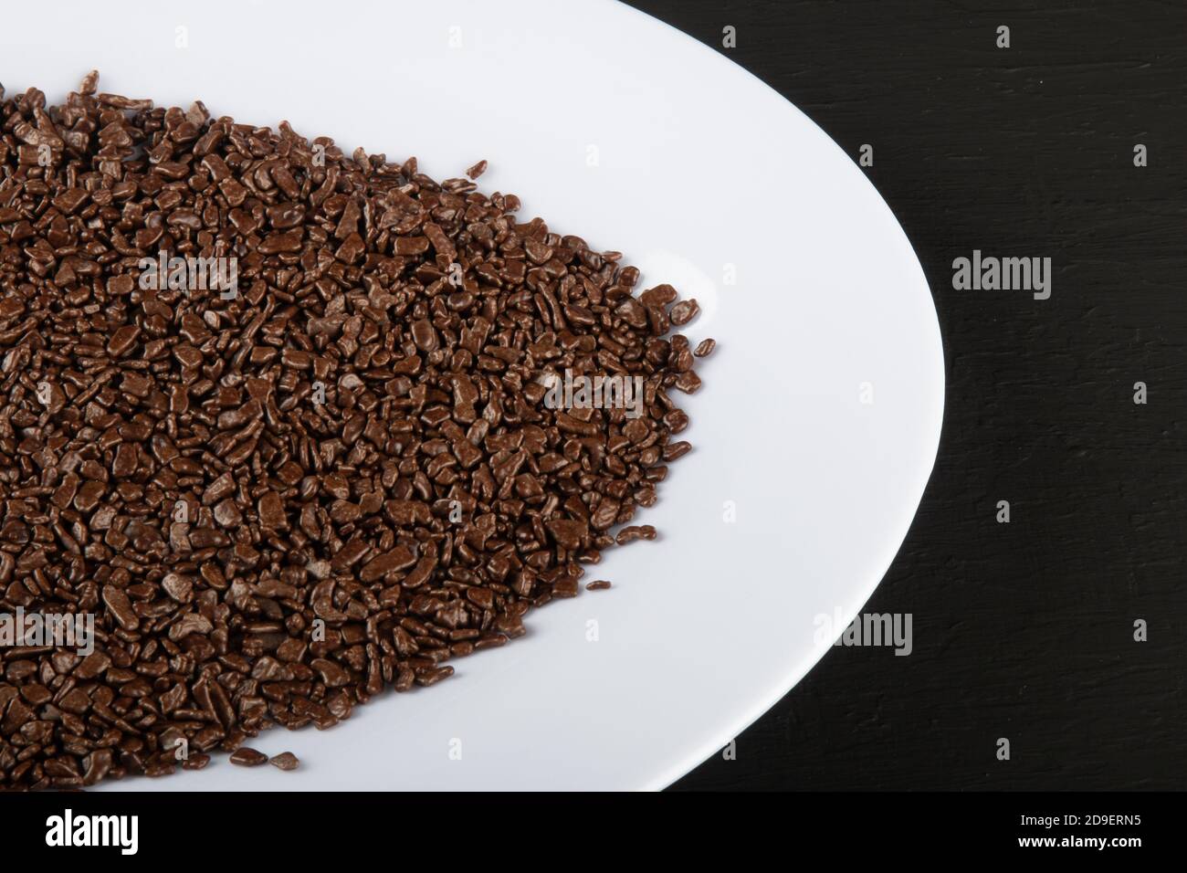 Chocolate sprinkles background. View of granulated chocolate Stock