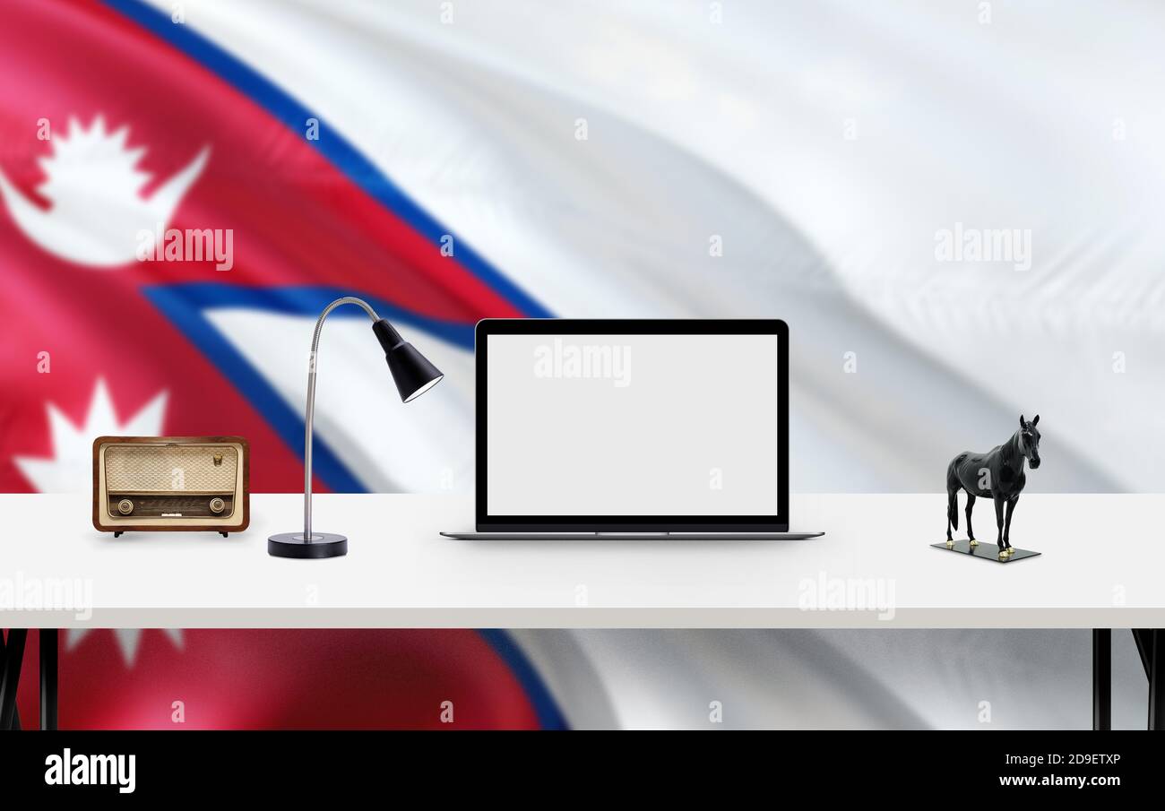 Nepal national flag background with workspace, desktop computer and office accessories on white