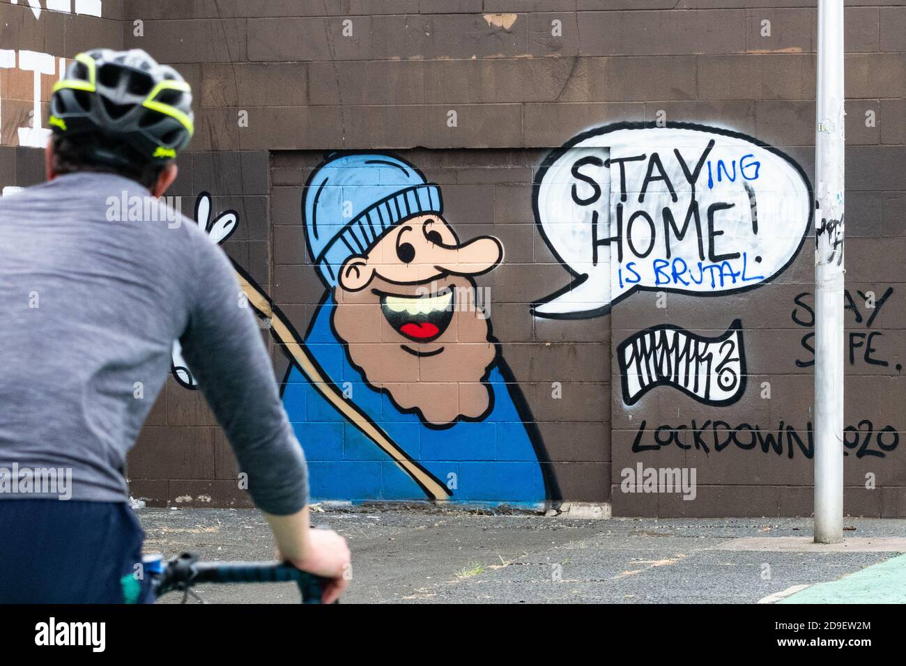 Mental health during lockdown - Stay Home coronavirus graffiti in Glasgow altered to read 'Staying at home is brutal' Glasgow, Scotland, UK June 2020 Stock Photo