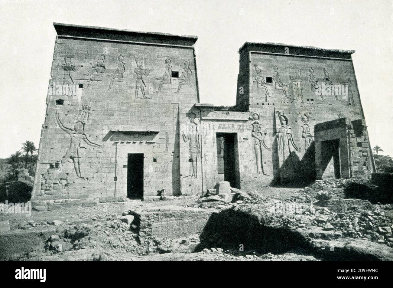 This photo shows the south front of temple of Isis at Philae - before the building of the Aswan Dam. Construction on the temple began around 280 B.C. Built during the reign of Ptolemy II (Egypt’s Greco-Roman Period), the Temple of Isis at Philae is dedicated to Isis, Osiris, and Horus. The temple walls contain Stock Photo