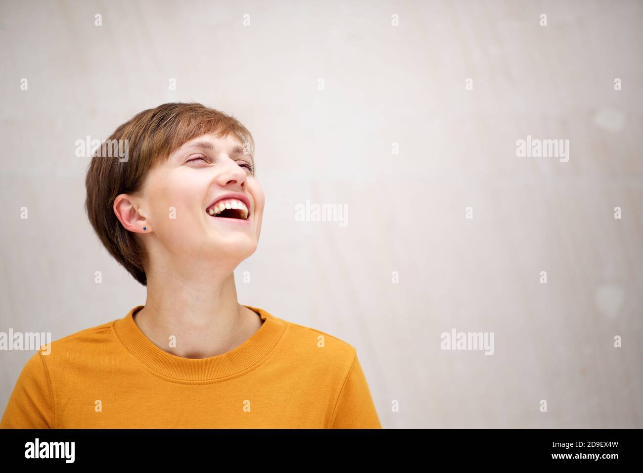 Close up horizontal portrait laughing young blond woman against white ...