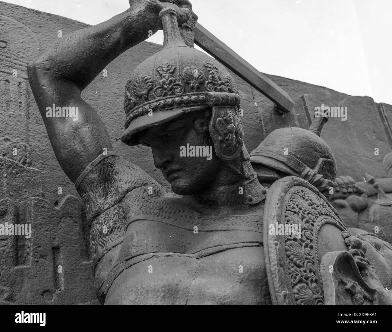 Sword in hand of warrior in armour of the medieval knight statue Stock Photo