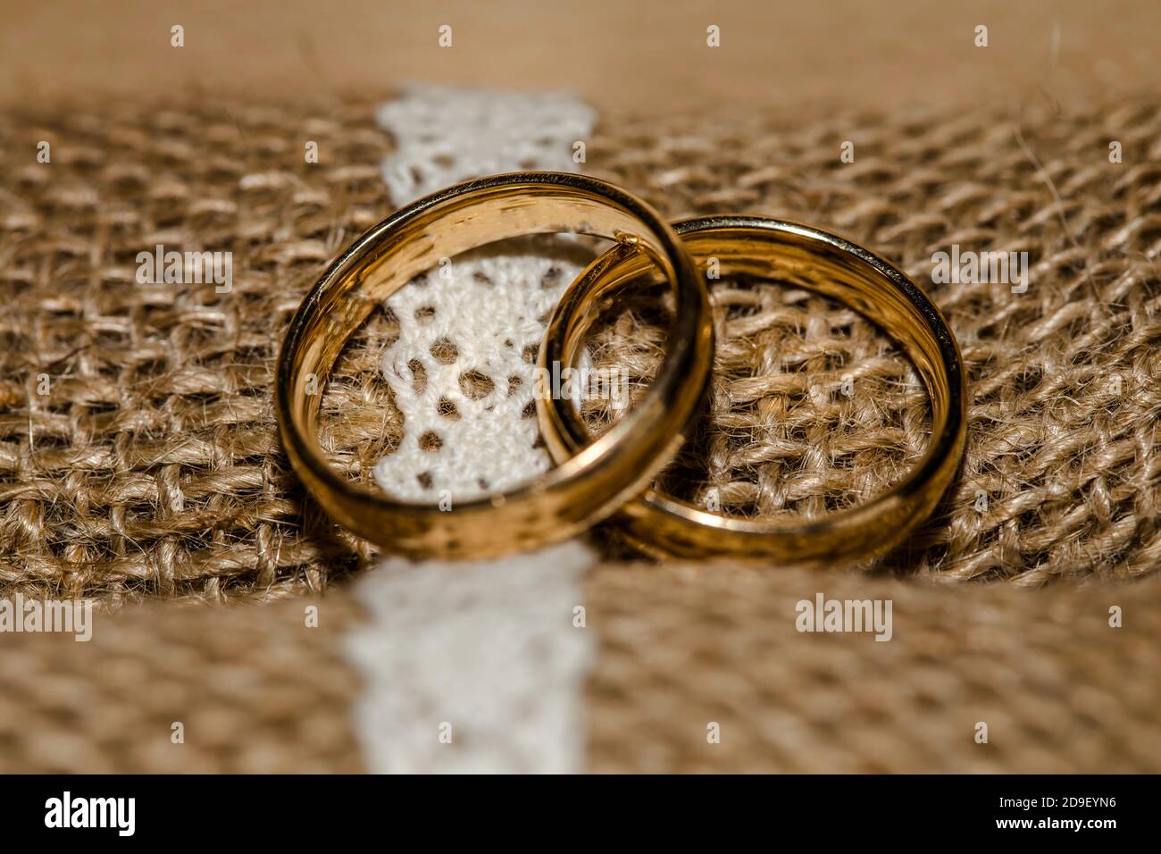 Wedding rings on a beautiful rustic lace, in the rustically box. Stock Photo