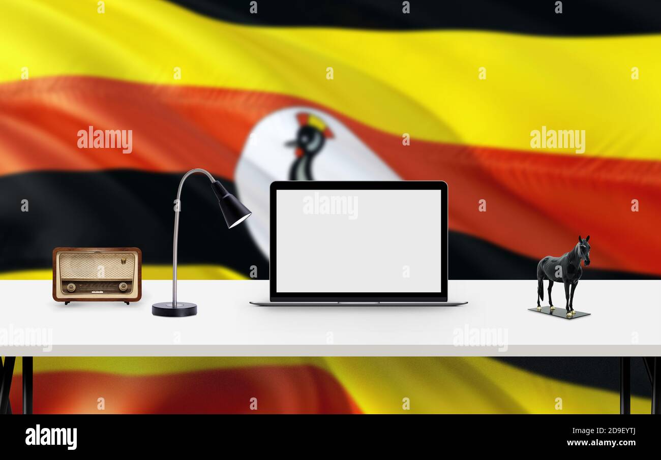 Uganda national flag background with workspace, desktop computer and