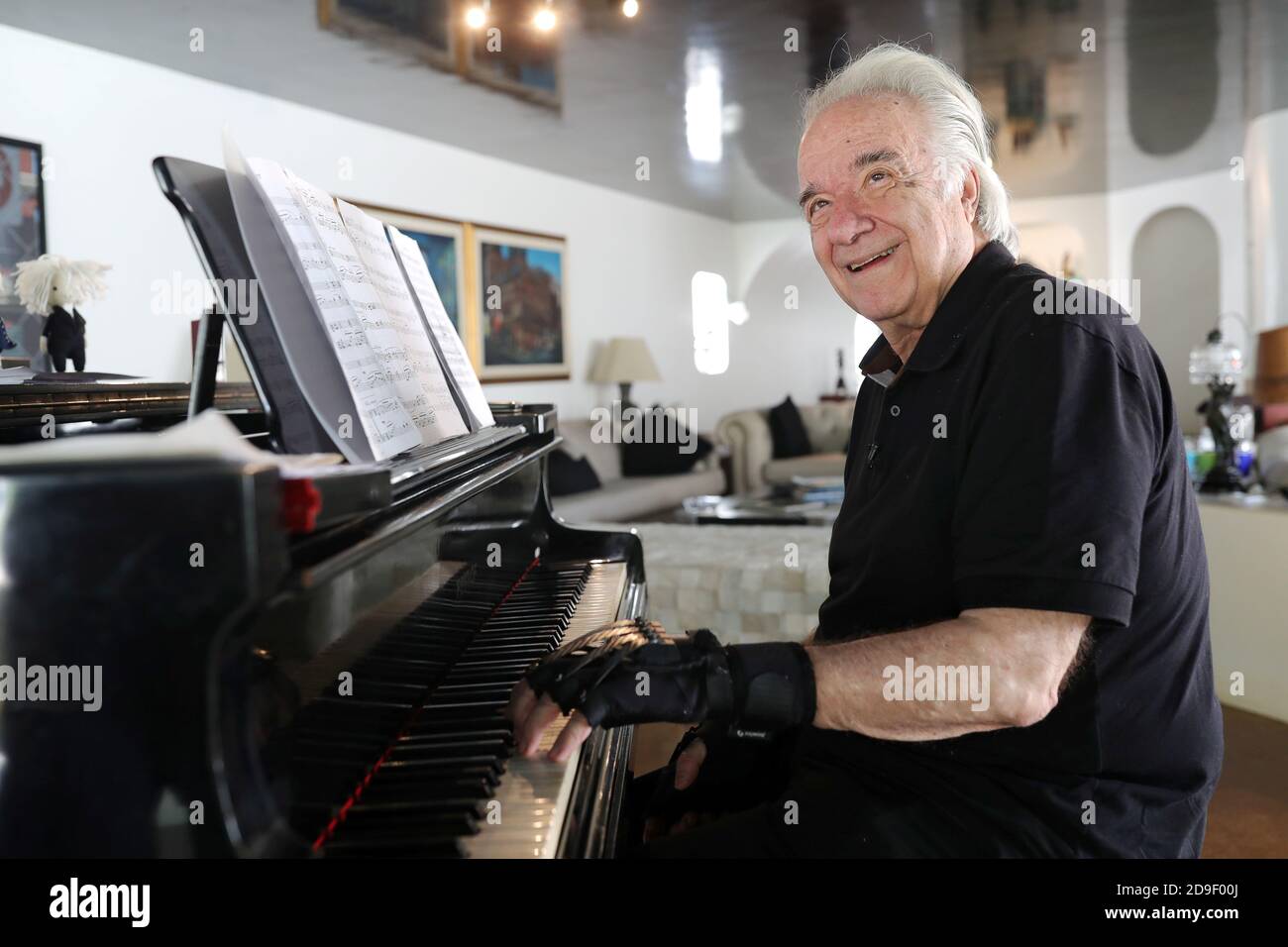 Brazilian Conductor And Pianist Joao Carlos Martins 80 Who After Many Years Lost The Ability To Play Due To Health Complications From Focal Dystonia Smiles As He Plays Piano With Bionic Gloves