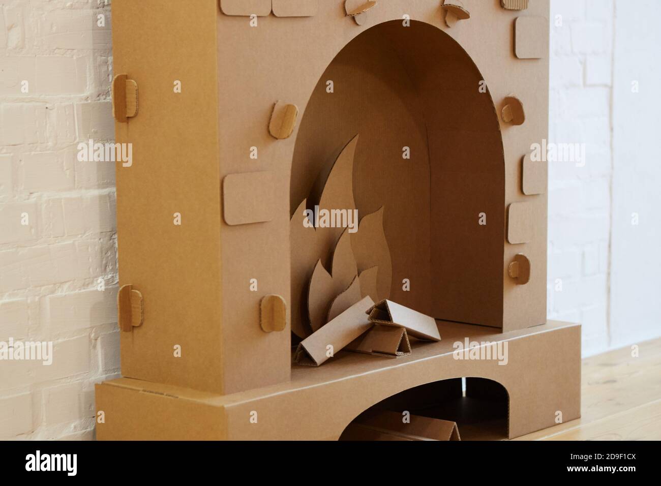 Cardboard fireplace. Closeup of firewood burning in fire Stock Photo