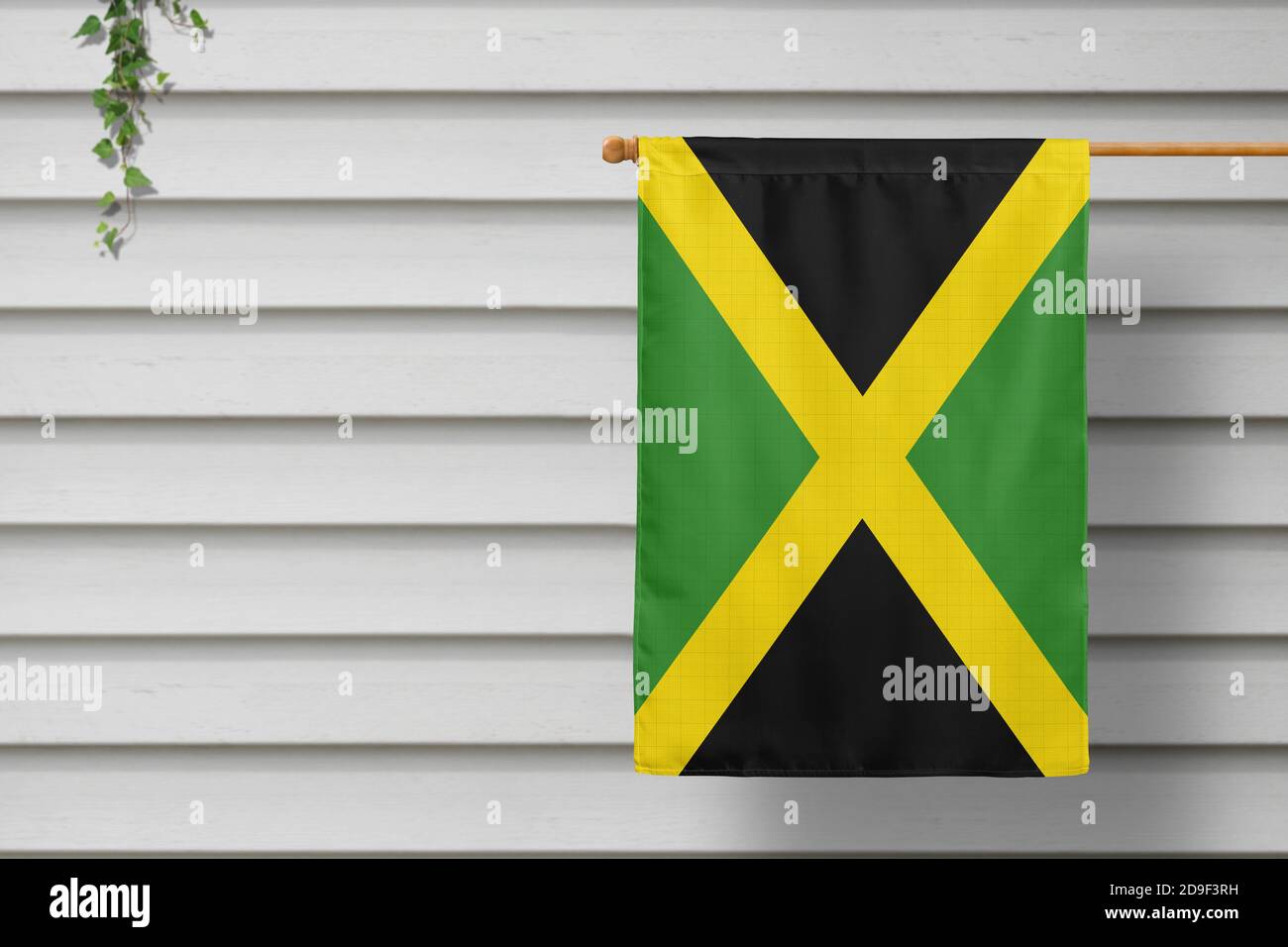 Jamaica national small flag hangs from a picket fence along the wooden