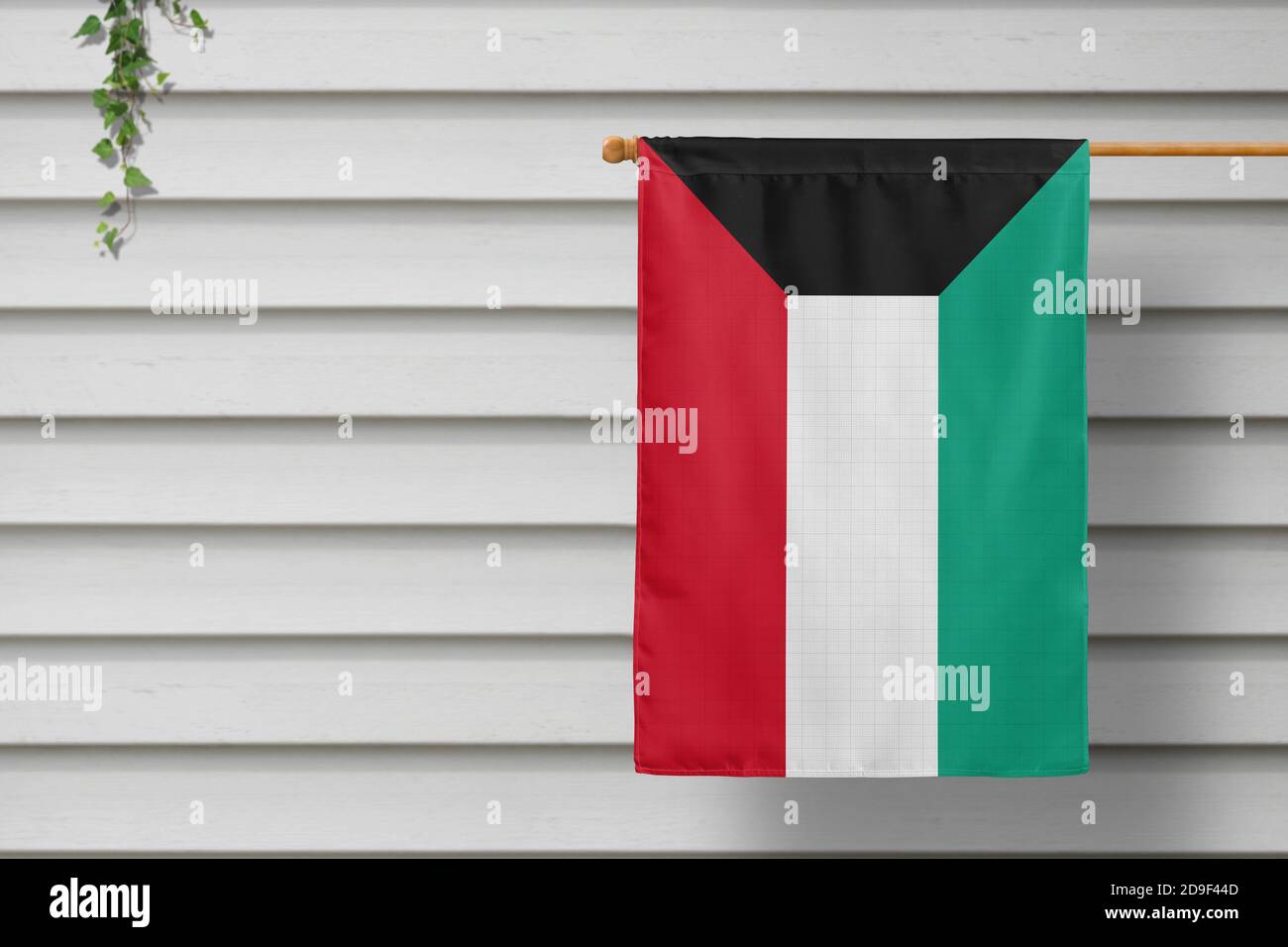 Kuwait national small flag hangs from a picket fence along the wooden ...