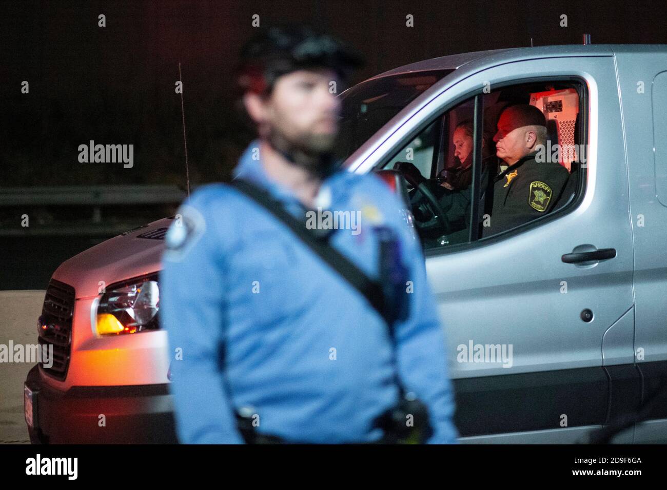 Minneapolis, Minnesota, USA. 4th Nov, 2020. Police drive behind the line of cops in an unmarked police van. Credit: Chris Juhn/ZUMA Wire/Alamy Live News Stock Photo