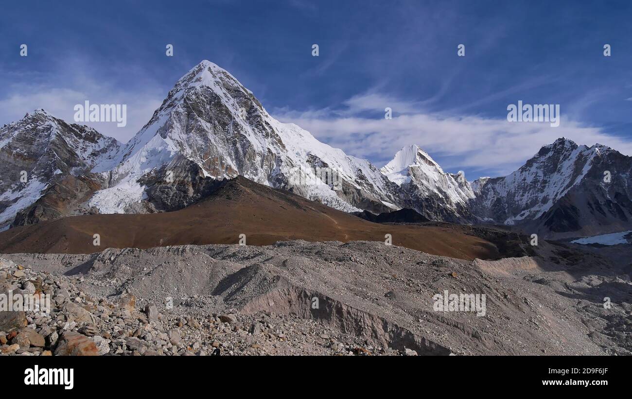 Stunning panorama view of mighty snow-capped mountain Pumori (summit 7,161 m) with Kala Patthar (5,645 m) below and famous Khumbu glacier, Nepal. Stock Photo