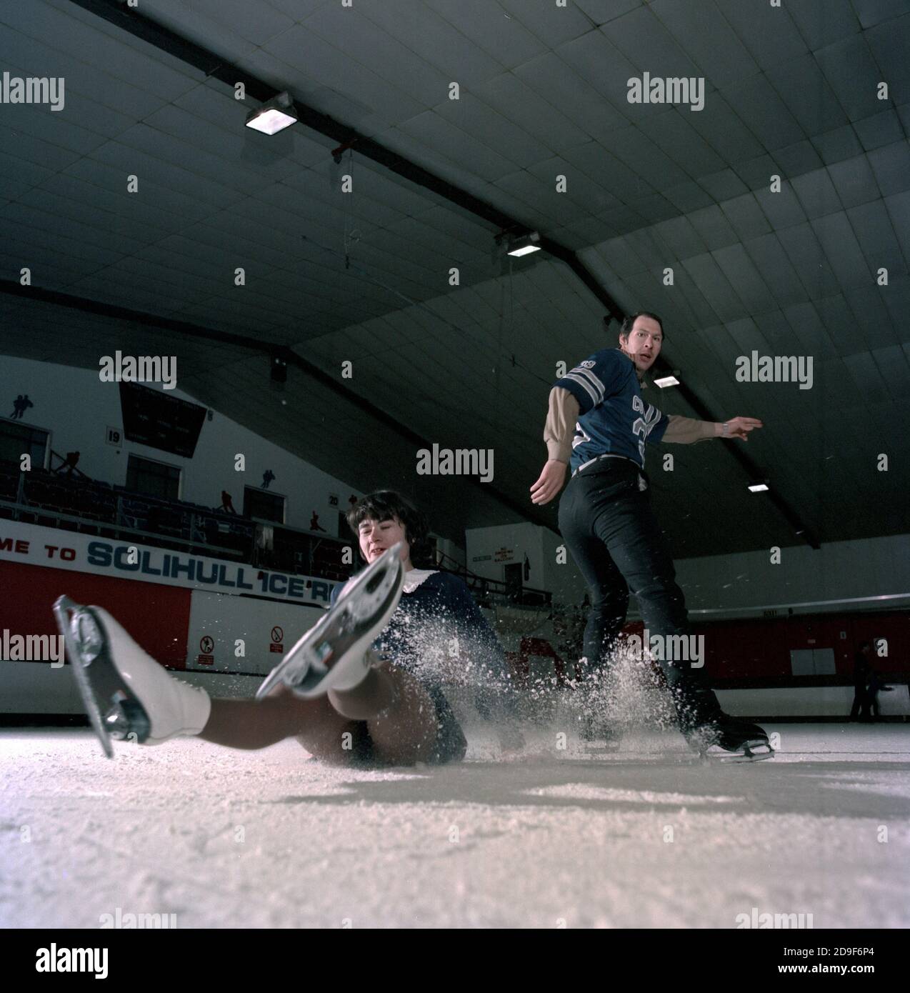 A woman skater takes a tumble from her partner at the Solihull Ice Rink