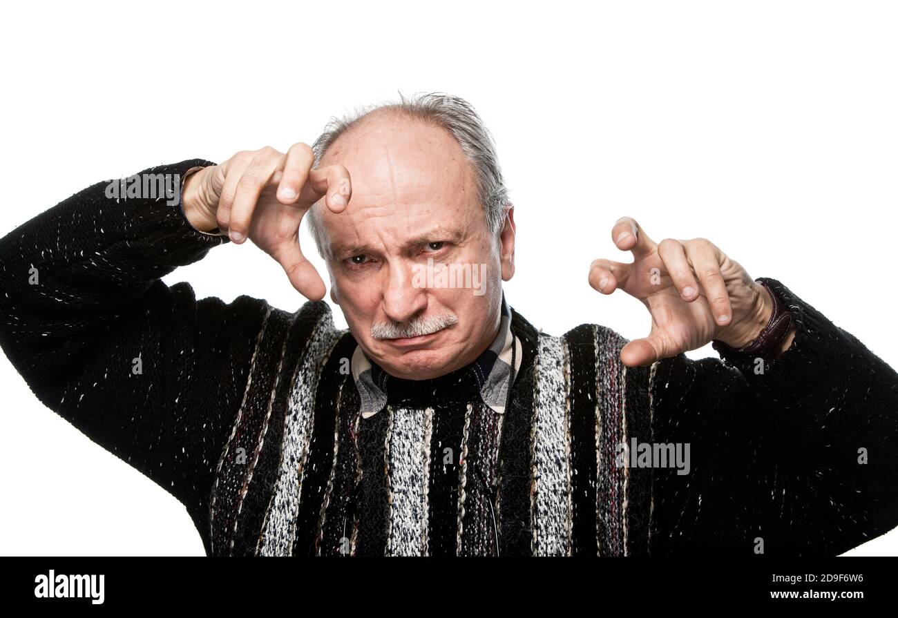 gesticulating offended elderly man with raised hands Stock Photo